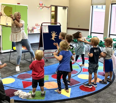 Image of Miss Eliza and storytime kids.