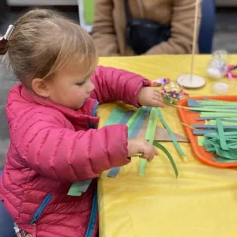Child cutting paper strips