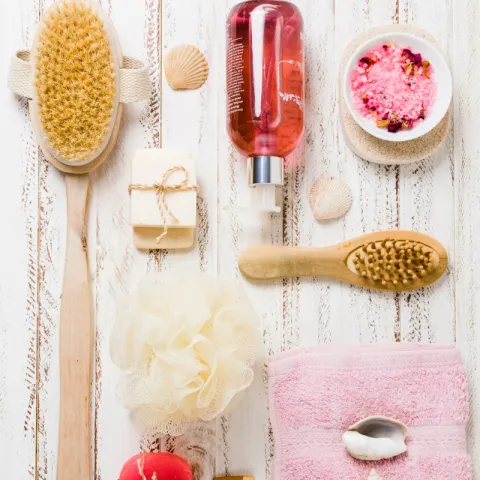Bathing supplies artfully arranged on a hardwood background.
