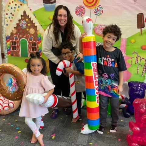 Image of family holding inflatable candy.