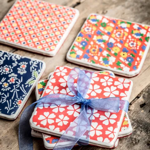Four brightly colored coasters on a table
