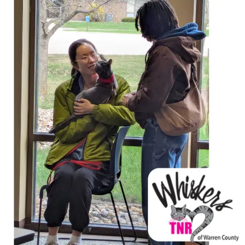 Image ow woman holding a cat.