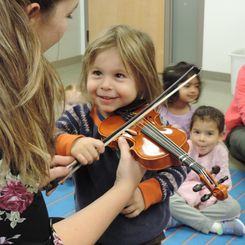 photo of toddler with instrument